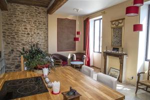 a kitchen and dining room with a wooden table at La Comédie de Pézenas - Appartements in Pézenas