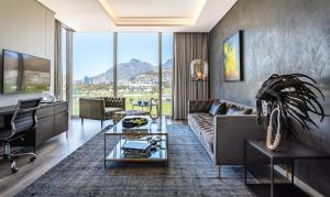 a living room with a couch and a table at O' Two Hotel in Cape Town