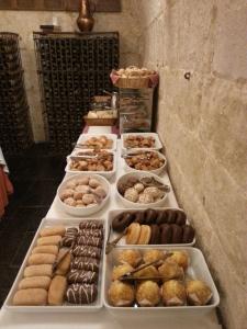 a table topped with lots of different types of pastries at Posada Real Castillo del Buen Amor in Villanueva de Cañedo