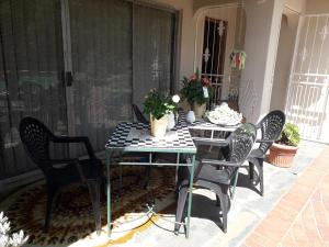 a table and chairs sitting on a patio at At The View B&B in Roodepoort