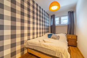 Posteľ alebo postele v izbe v ubytovaní Apartamenty Lisowski CENTRUM Zborowskiego
