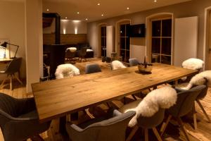 a dining room with a wooden table and chairs at Chalet Sonnenbichl in Garmisch-Partenkirchen