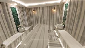 a bathroom with two sinks and two windows at Sarnic Premier Hotel in Istanbul +26 photos