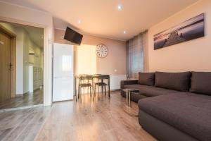 a living room with a couch and a table at Apartments Bracic Spa in Sukošan