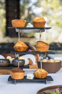 a three tiered display of muffins on a table at Calfuco Wine Hotel & Spa in Villa La Angostura