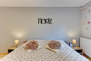 a bedroom with a bed with two pillows on it at Villa Arkodes in Gdańsk