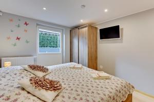 a bedroom with a bed with two pillows on it at Villa Arkodes in Gdańsk