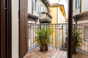 a balcony with two potted plants on a building at Apartment Goethe 1 in Bolzano