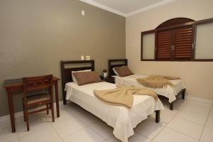 Un pat sau paturi într-o cameră la Hotel Recreio dos Bandeirantes