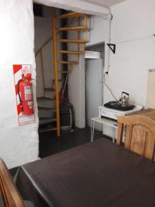 cocina con mesa y boca de incendios en una habitación en La Higuerita en Capilla del Monte