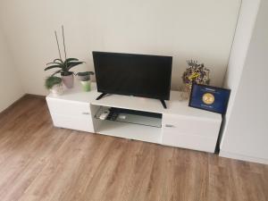 a white entertainment center with a flat screen tv on it at Apartman MMS in Teslić