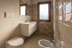 a bathroom with a white toilet and a sink at Foresteria Lombarda GELSO BIANCO in Cogliate