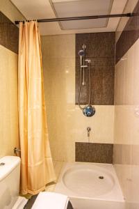 a bathroom with a shower and a toilet and a sink at Lux BnB Studio Park Tower DIFC in Dubai