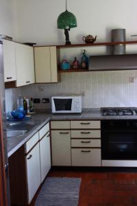 eine Küche mit einer Spüle und einer Mikrowelle in der Unterkunft La Ca' Nova in Lurago D'Erba 