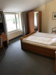 a bedroom with a large bed and a window at Landgasthaus Streichmühle in Dollerup