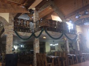 um restaurante com uma grande sala com uma varanda em КРЕМІНЬ em Dragobrat