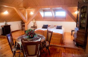 a bedroom with a bed and a table in a room at Nowy Dom Polska in Magnuszew