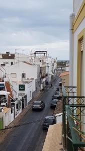 a city street with cars parked on the street at appartement cabanas de tavira bord de mer in Cabanas de Tavira