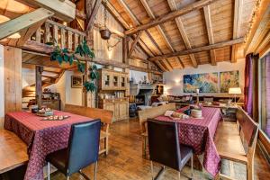 a dining room with two tables and a kitchen at Chalet Tissi&egrave;res in Chamonix-Mont-Blanc