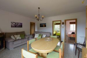 a living room with a table and a couch at Apartaments La Pertusa 2 in Corçà