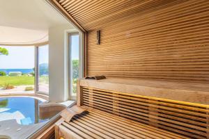 a sauna with a view of a swimming pool at Centro Vacanze Isuledda in Cannigione