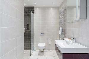 
a bathroom with a sink, toilet and bathtub at Room Space Service Apartments – New Manor House in Bracknell
