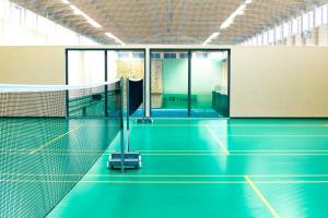 an empty tennis court with a net at Amenity Hotel & Resort Lipno in Lipno nad Vltavou