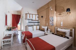 a hotel room with two beds and a kitchen at Oasis Studios in Malia +80 photos