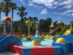 a water park with a bunch of slides and rides at Camping Resort La Baume La Palmeraie in Fréjus