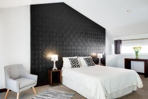 Postel nebo postele na pokoji v ubytování Hotel Casa Gardenia