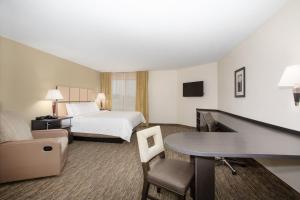a hotel room with a bed and a desk at Candlewood Suites Manhattan, an IHG Hotel in Manhattan