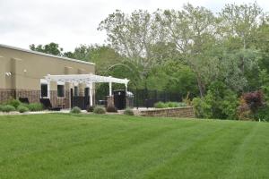 a house with a lawn in front of a building at Candlewood Suites Independence, an IHG Hotel in Selsa