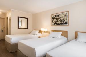 Postel nebo postele na pokoji v ubytování Alfa Suites - Montevideo