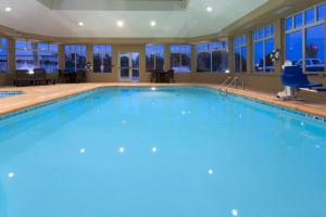 a large swimming pool with blue water at Holiday Inn Express & Suites Moultrie by IHG in Moultrie