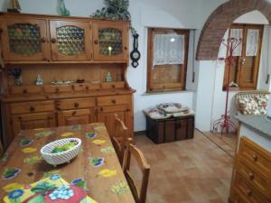 a kitchen with a table and a dining room at Casa Marisa in Bibbiena