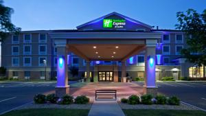 a hotel with a sign on the front of a building at Holiday Inn Express Hotel & Suites Rogers, an IHG Hotel in Rogers
