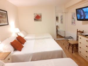 a hotel room with two beds and a flat screen tv at Athlumney Manor Guest Accommodation in Navan