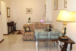 a living room with a table and a couch at BEAUTIFUL HOLIDAY HOUSE by Marcos in Sanremo