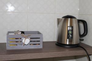 a tea kettle and a box on a table at BEAUTIFUL HOLIDAY HOUSE by Marcos in Sanremo