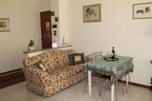a living room with a couch and a table at BEAUTIFUL HOLIDAY HOUSE by Marcos in Sanremo +18 photos