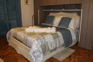 a bedroom with a large bed with towels on it at BEAUTIFUL HOLIDAY HOUSE by Marcos in Sanremo
