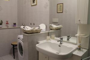 a bathroom with a sink and a washing machine at BEAUTIFUL HOLIDAY HOUSE by Marcos in Sanremo