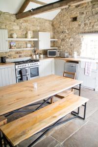 a kitchen with a wooden table in a room at Swinton Park in Masham