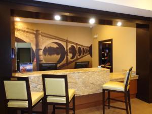a lobby with a bar with chairs and a counter at Staybridge Suites Longview, an IHG Hotel in Longview