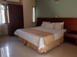Postel nebo postele na pokoji v ubytování Hotel Poblado Campestre