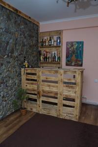 a room with a wooden cabinet and a stone wall at Эдельвейс in Tsaghkadzor