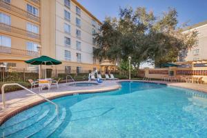 a swimming pool in front of a building at La Quinta by Wyndham Ocala in Ocala