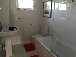 a bathroom with a toilet and a sink and a shower at Unique Garden Centre Country Cottage in Fraserburgh