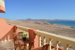 a balcony with a table and a view of the beach at APARTAMENTO ANA in Costa Calma