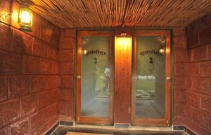a brick building with three glass doors on it at Anandvan Holiday Homes, Wai in Wai +57 photos